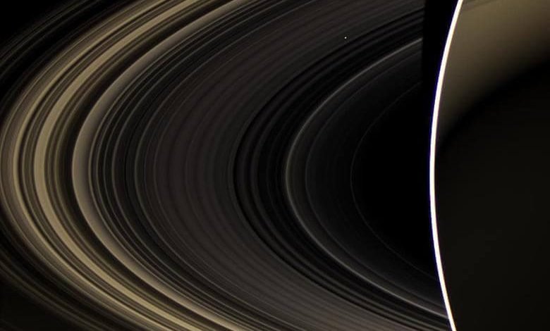 Cassini, bir fotoğrafa iki gezegeni sığdırdı. Arkadaki küçük parlak nokta Venüs.
